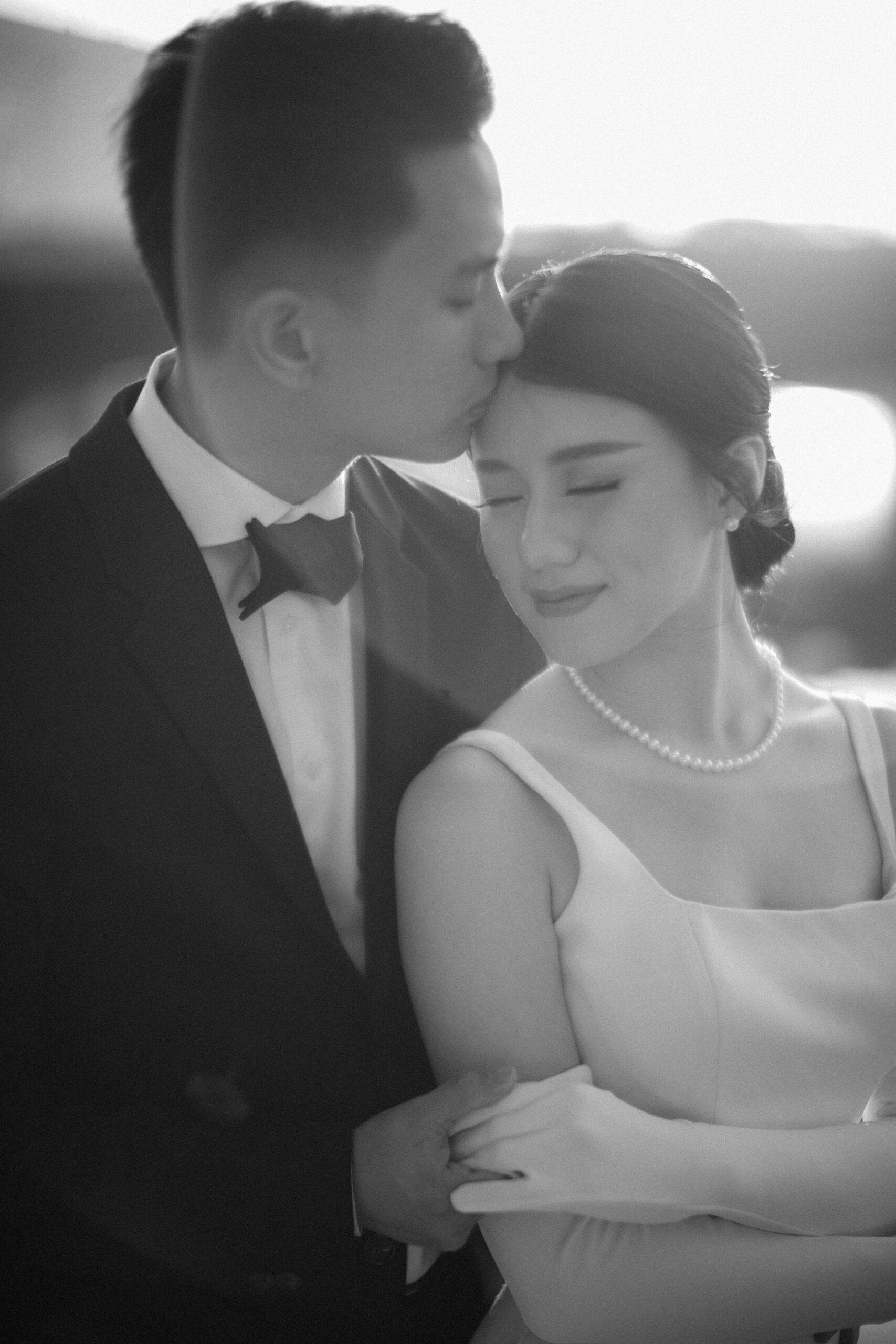 Groom holding bride hand.