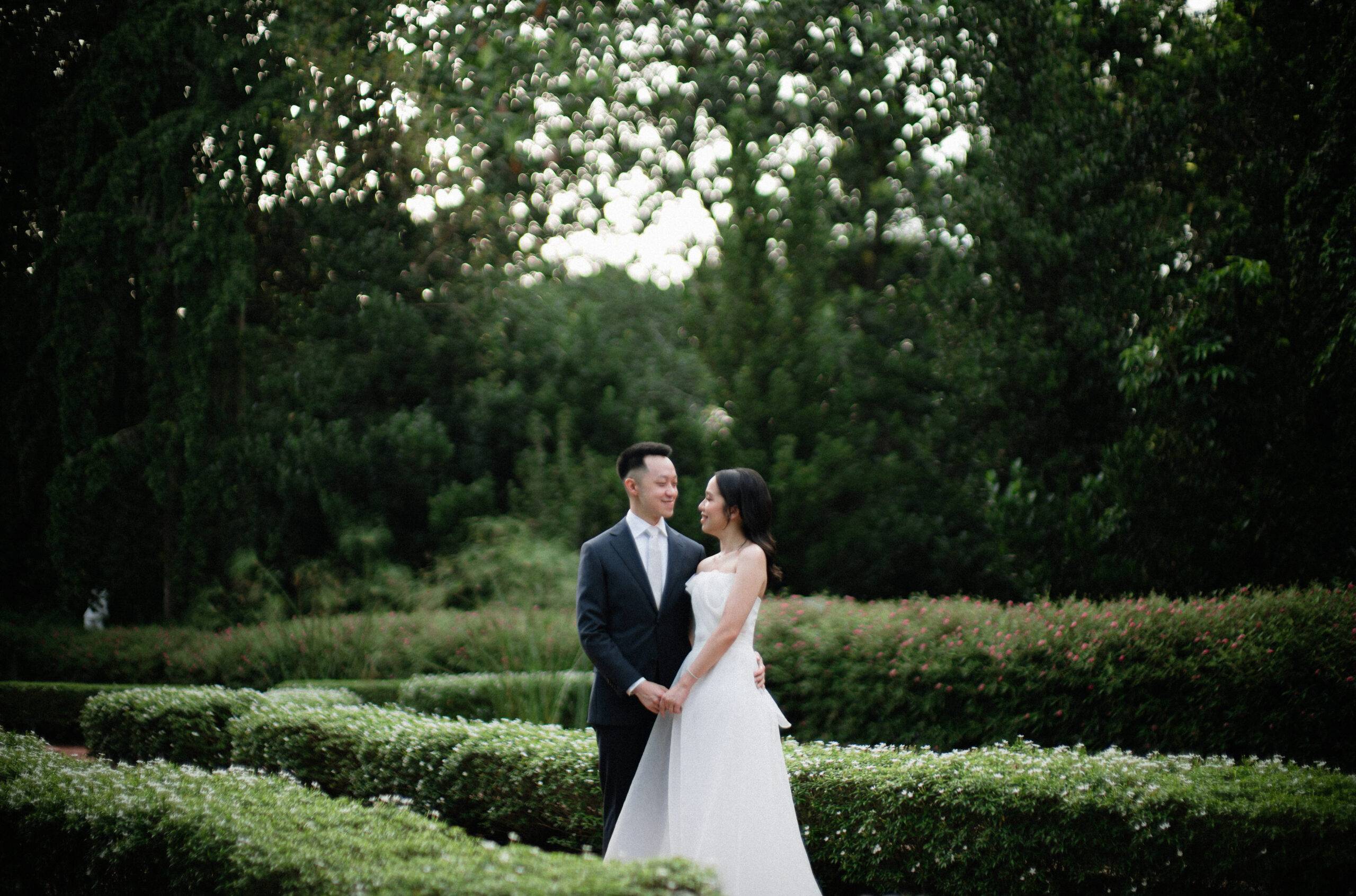 Bride and Groom holding hands looking at each other